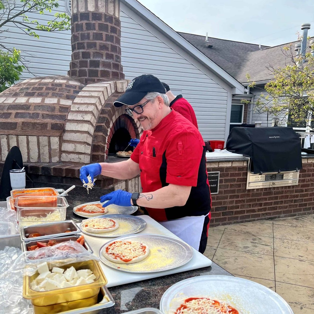 A chef cooks fresh pizzas at a Willow Brook community event in Delaware, Ohio, used as the Careers page header circle image.