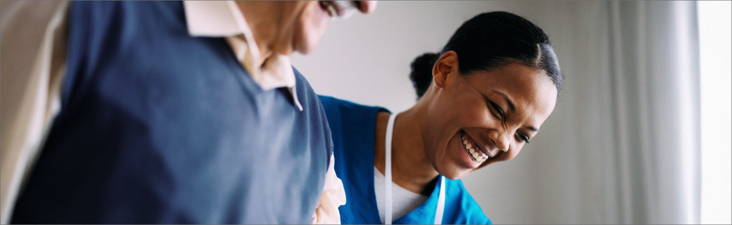 Wide desktop banner of a caregiver and resident at Willow Brook in Delaware, Ohio, used as the Careers page header for this senior living community.