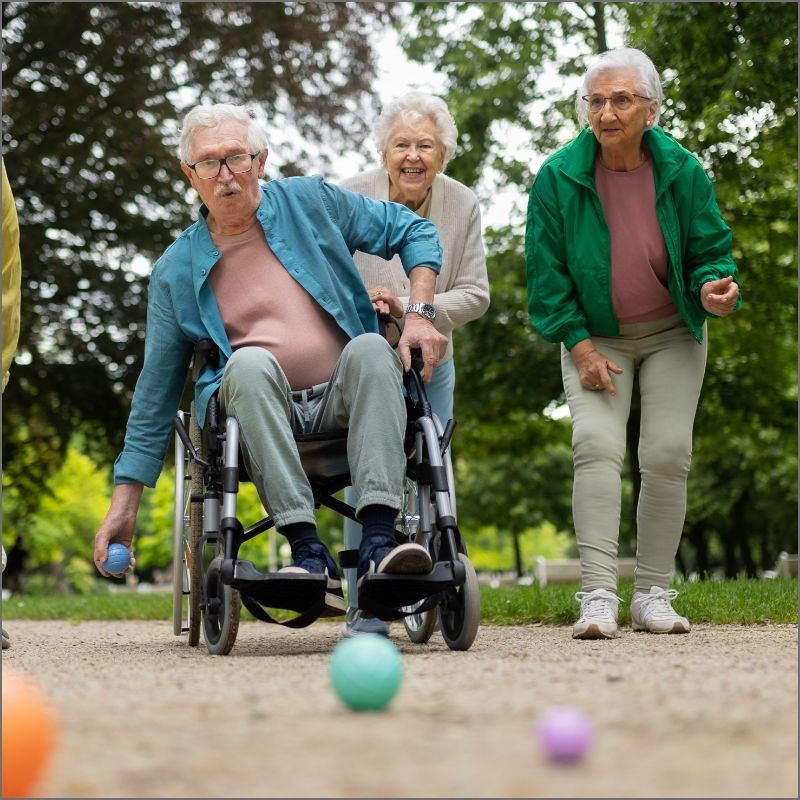 Residents enjoy a friendly bocce ball game at Willow Brook in Delaware, Ohio, used as the About page mobile header for this active senior living community.