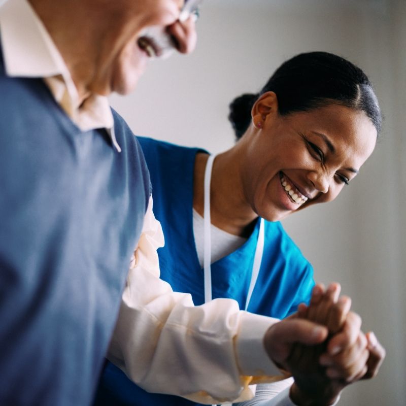 A Willow Brook caregiver shares a warm moment with a resident, used as the mobile header for the Careers page of this Delaware, Ohio senior living community.
