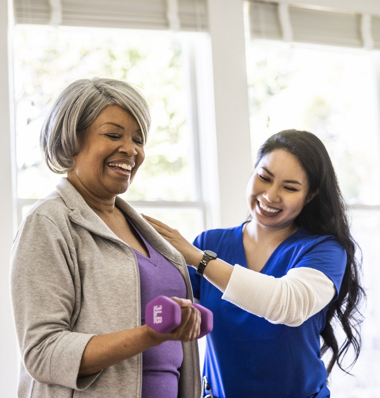A senior strengthens her arms with a caregiver's support at Willow Brook in Delaware, Ohio, featured in the rehabilitation lifestyle section of the home page.