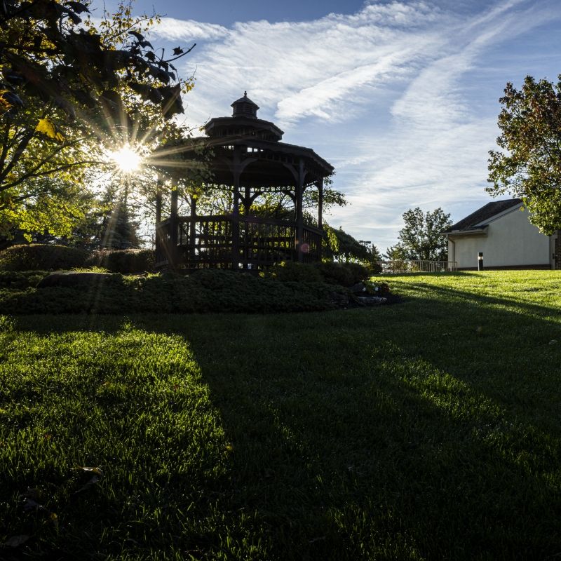 Sunlit gazebo on the Willow Brook campus in Delaware, Ohio, used as the mobile header for the newsletter page of this senior living community.