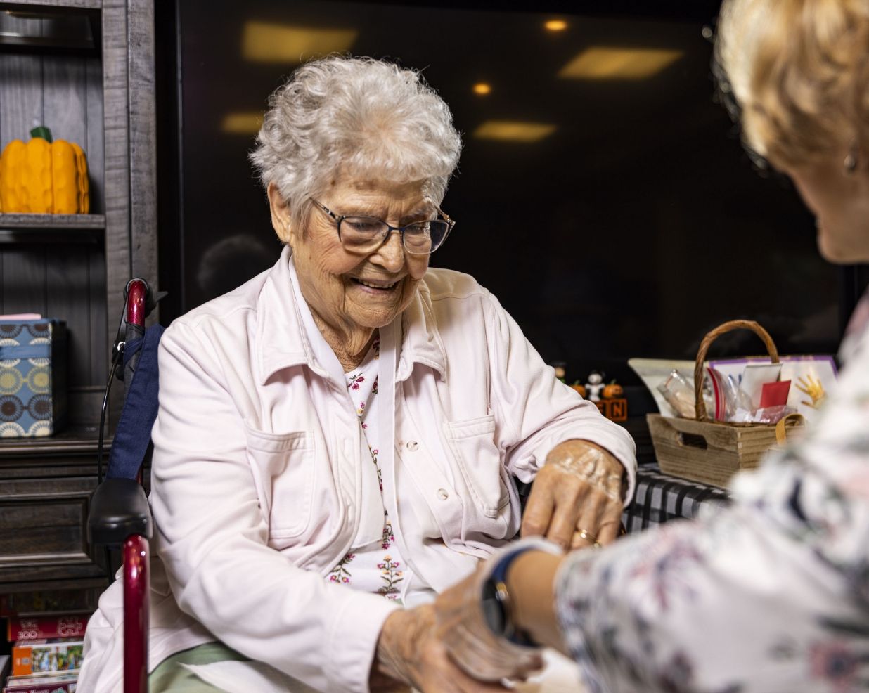 A resident shares a moment with a caregiver at Willow Brook Run in Delaware, Ohio, used in the assisted living financial section.