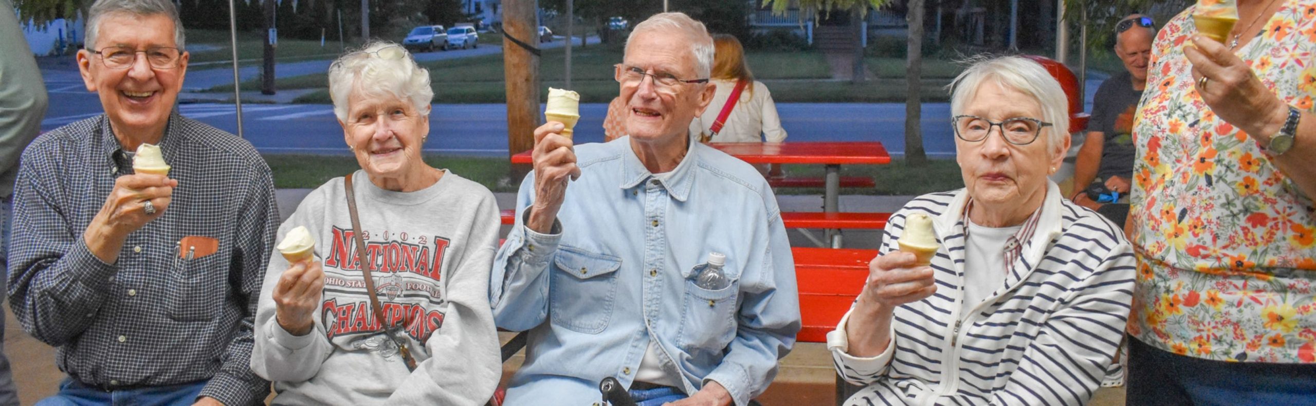 Wide desktop banner showing residents enjoying ice cream at Willow Brook Run in Delaware, Ohio, used as the Life Enrichment page header.