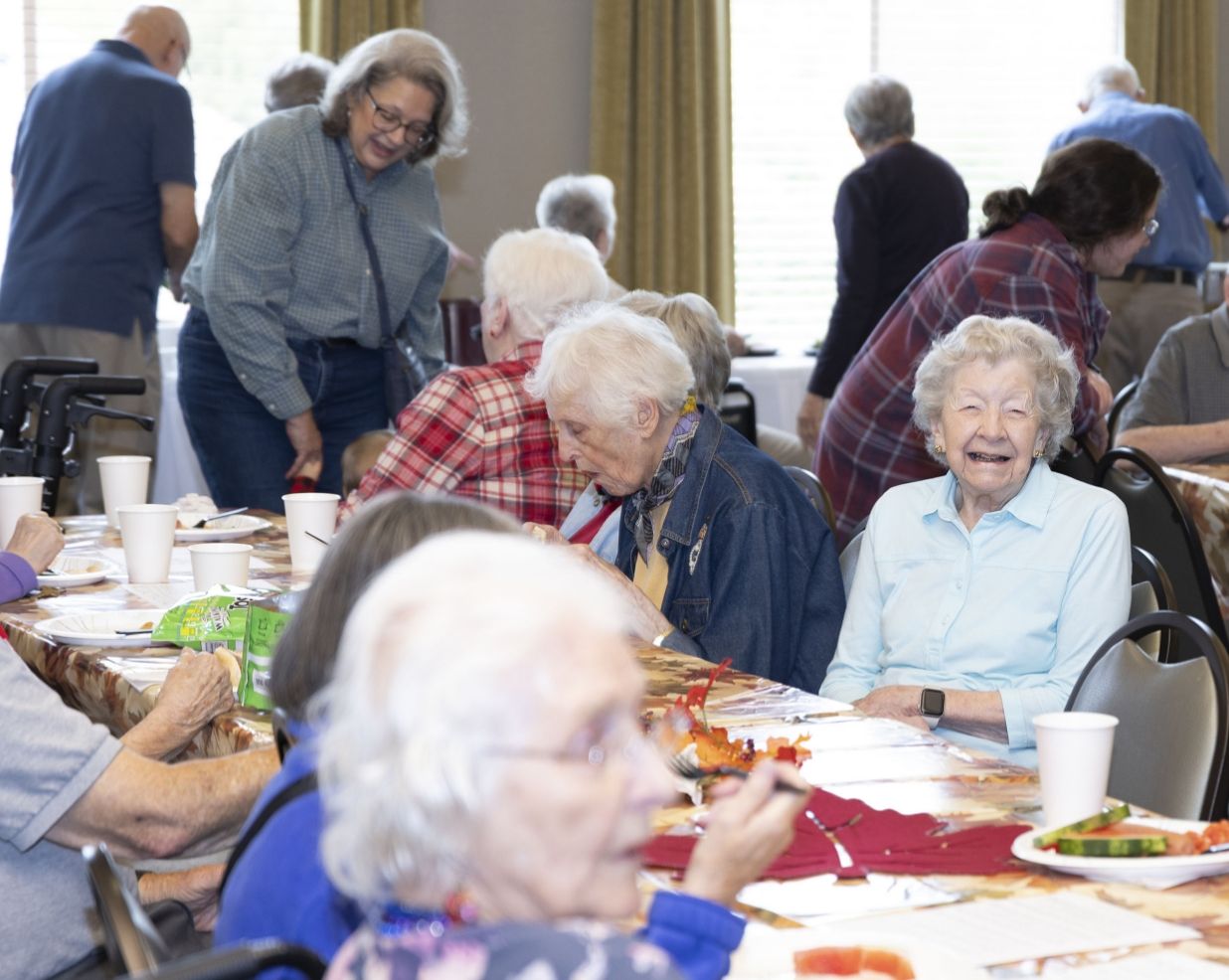 A community gathering at Willow Brook Run in Delaware, Ohio, where transitional living residents share meals and connect with caregivers.