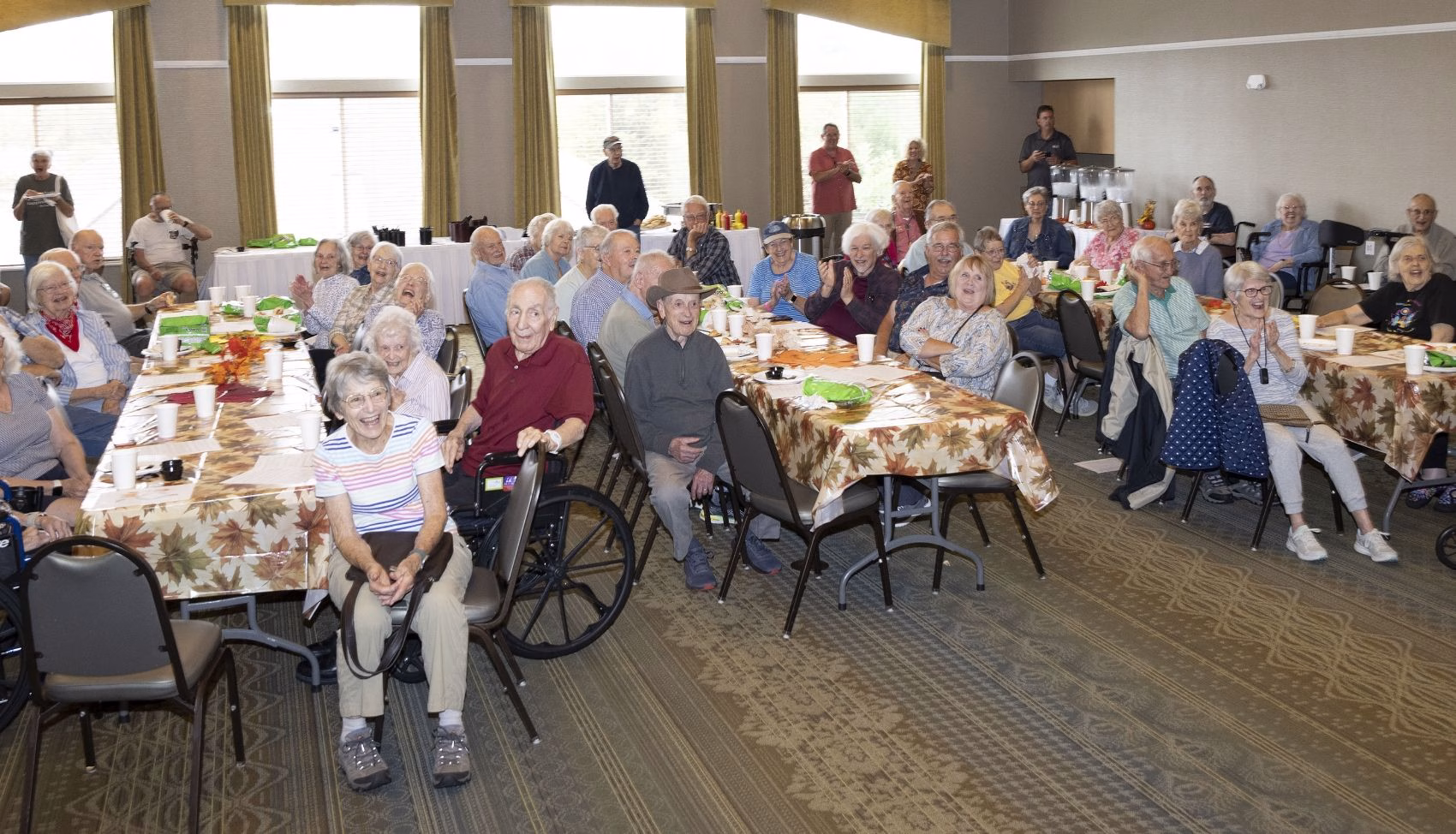 Residents gather for a community panel discussion in a Willow Brook banquet room, reflecting the active social calendar that defines life at this Delaware, Ohio senior living community.